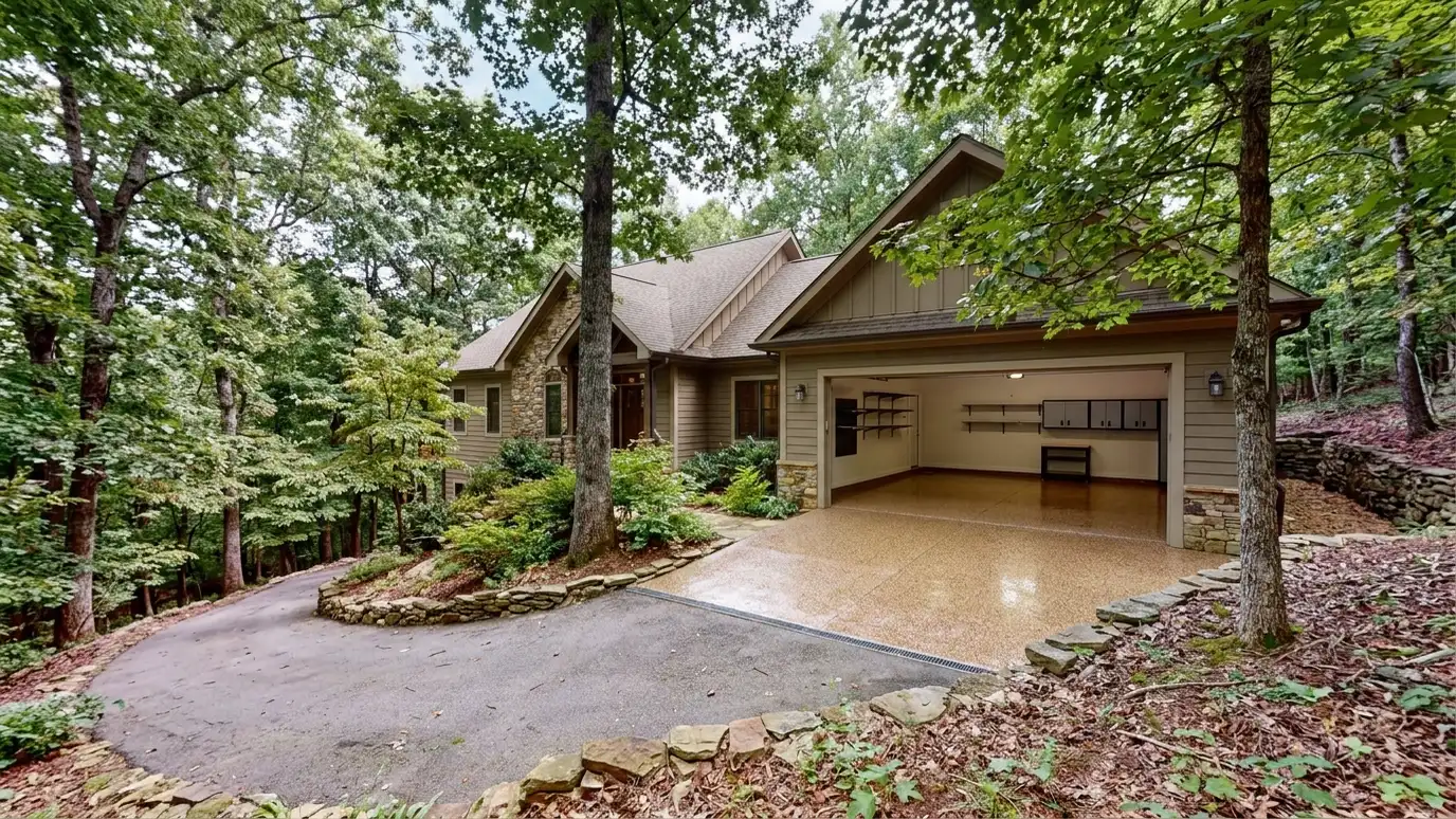 A Kingston Springs, Tennessee home with the garage door open showing a glossy coated flake floor inside