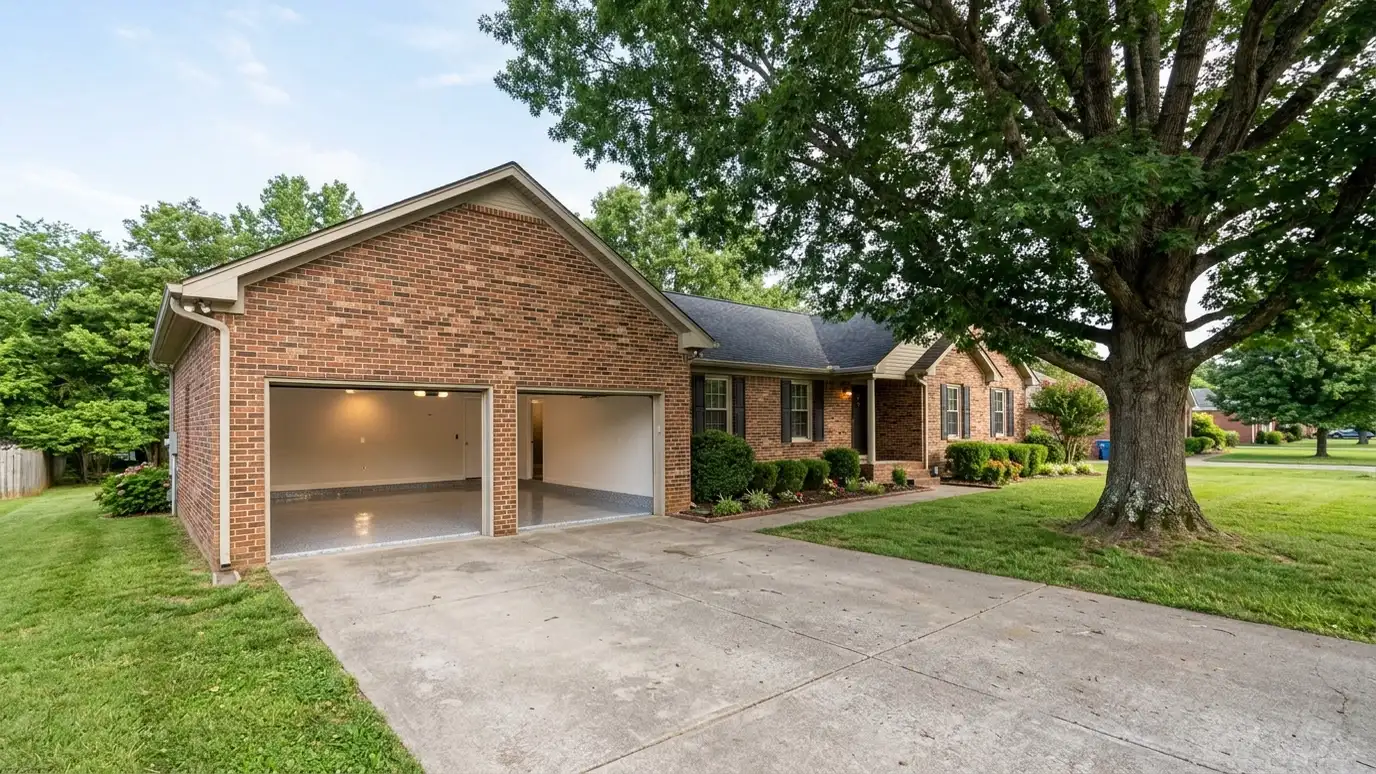 A Lebanon, Tennessee home with the garage door open showing a glossy coated flake floor inside