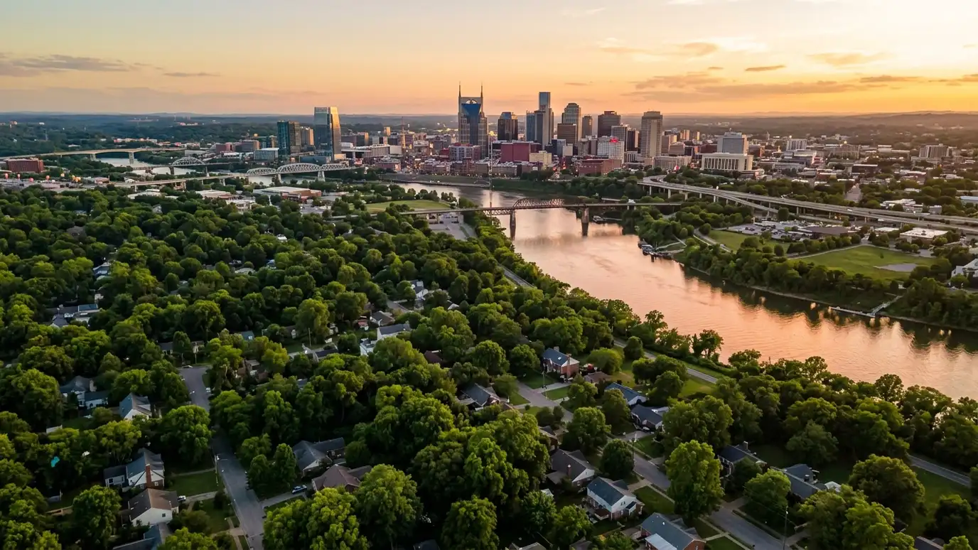 Garage floor coating service areas | Nashville and Middle Tennessee A golden sunset aerial view of the Nashville skyline above tree-covered neighborhoods with suburban homes and a winding river